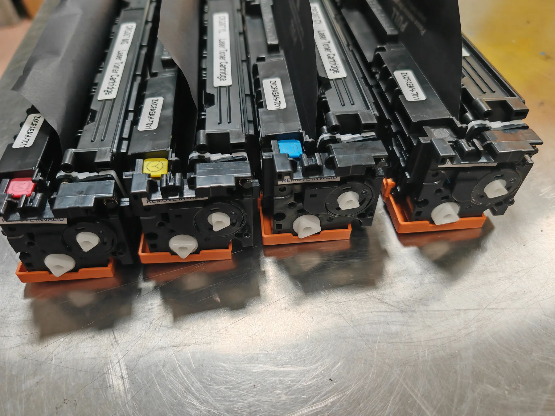 Real Canon CRG067 compatible toner cartridge photos showing BK, cyan, yellow and magenta labels